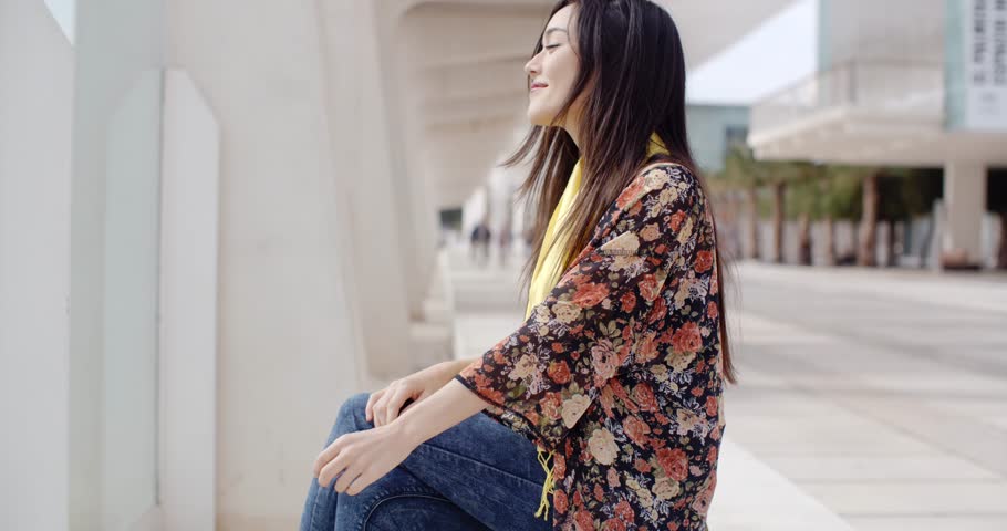 Attractive elegant young woman relaxing in town