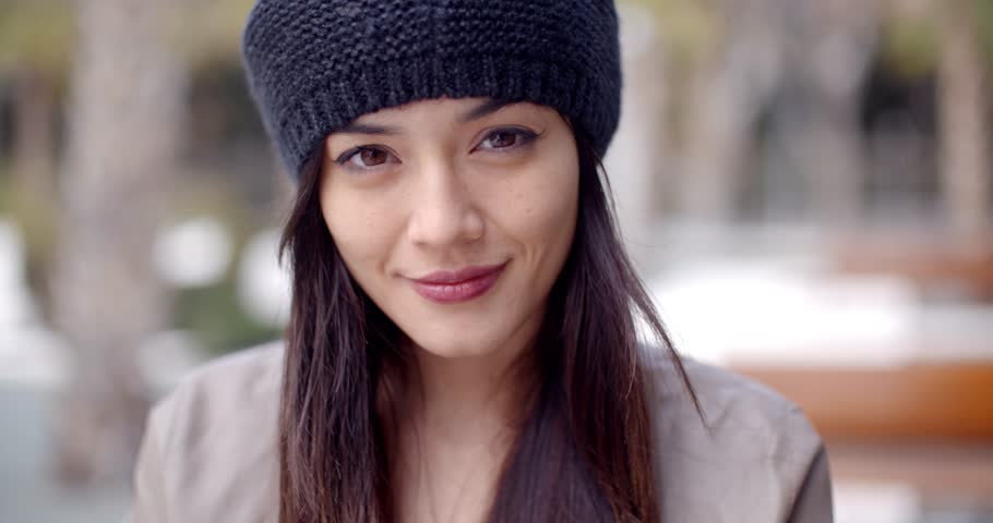 Pretty thoughtful young woman in a woolly cap