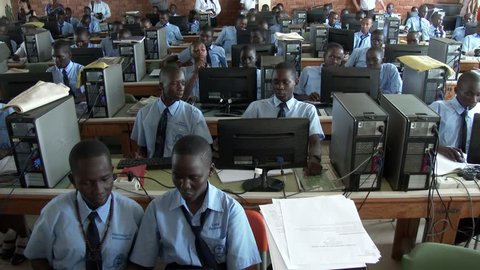 KAMPALA, UGANDA, OCTOBER 2015: Long shot and pan - African students studying at computer lab in school - Education in Africa