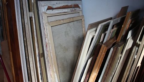 Shelving in the artist's studio for storing canvases and paintings. Art storage shelves. Storing canvas, frame, papers and boards