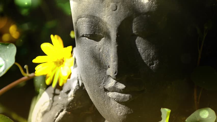 Statue in beautiful garden. Rice Goddess from Indonesia.