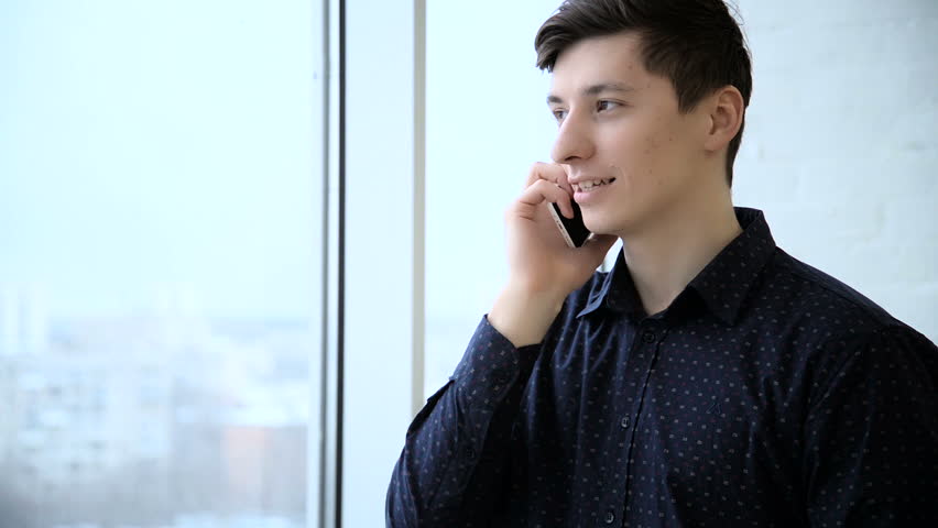 Business man leaving office and answering phone call