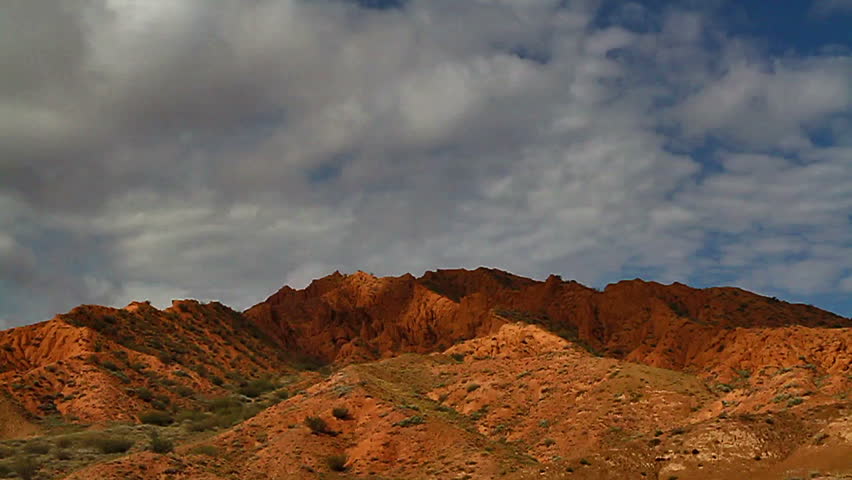 Time lapse. clouds quickly run over the red mountains