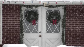 Festive Christmas decorations on doorway outside through the falling snow. - Powered by Shutterstock - Get 15% off with code: PIKWIZARD15