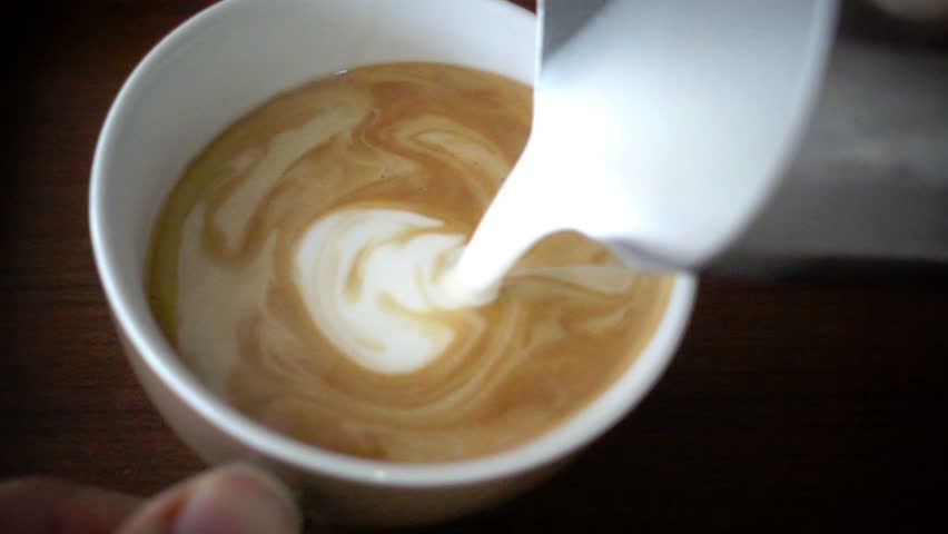 Pouring stream milk into a cup of espresso, slow motion | Shutterstock HD Video #14422507