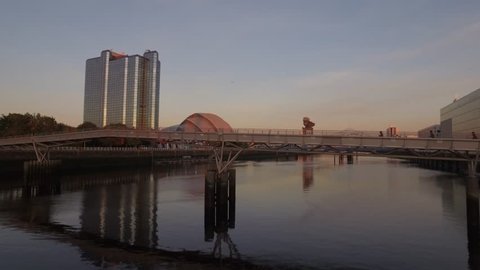 Aerial drone view, along the River Clyde, of Glasgow skyline at sunset.