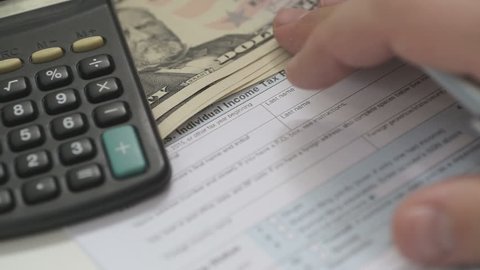 Man Filling Out Tax Form