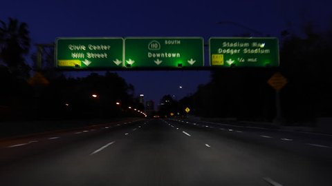 LOS ANGELES, CALIFORNIA, USA - February 7, 2016:  Downtown Los Angeles 110 Freeway signs night moving shot.