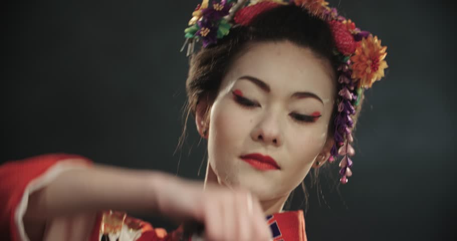 4k Close up of a beautiful Japanese Geisha posing for the camera, slow motion