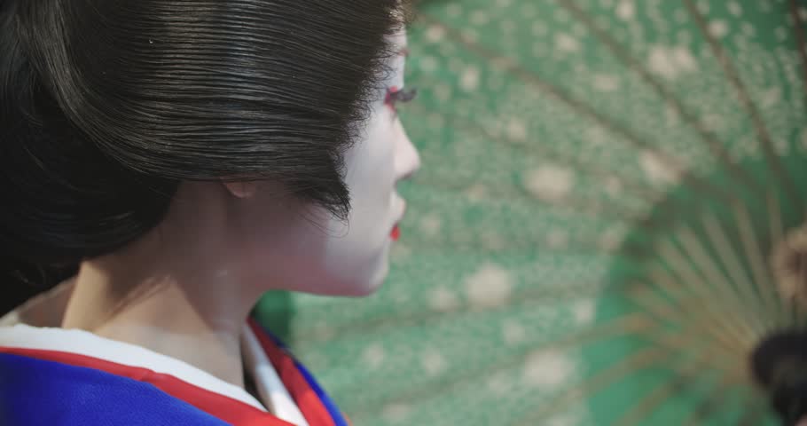 4k Close up of a beautiful Japanese Geisha posing for the camera, slow motion