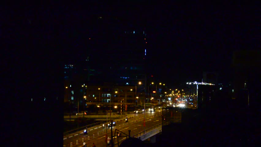 People diving car and riding motorcycle at traffic road near Ben Thanh Market in night time in Ho Chi Minh, Vietnam