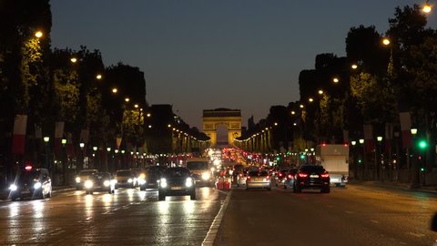 PARIS, FRANCE, JULY 17, 2015 4K Triumph Arch Sunset Traffic Paris Traveling Illuminated Champs Elysees France