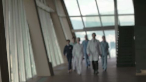 doctors team walking in modern hospital corridor indoors, poeople group