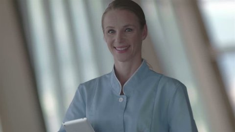 portrait of female doctor holding tablet computer at hospital