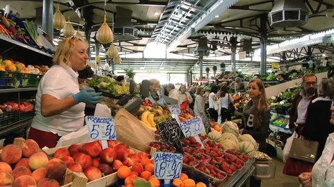 MODENA, ITALY – MAY 15, 2013: Unidentified people do shopping at the Old Market in Modena, Italy.