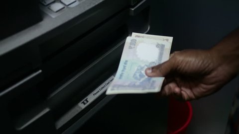 Hand of indian man withdrawing cash from ATM