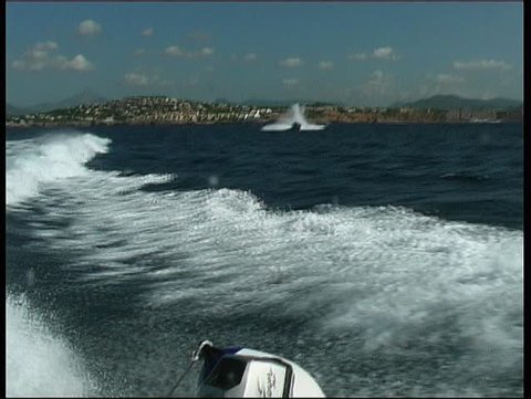 Fast daycruiser jumping backwash of motoryacht take 4
