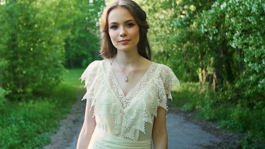 Young woman talking on a blossoming garden.