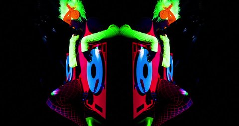 sexy female DJ mixes in a club in UV fluorescent costume