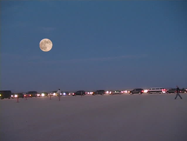 Moon worshipers leaving a gathering in the middle of the desert.