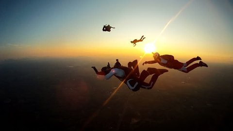 Skydiving sunset silhouette