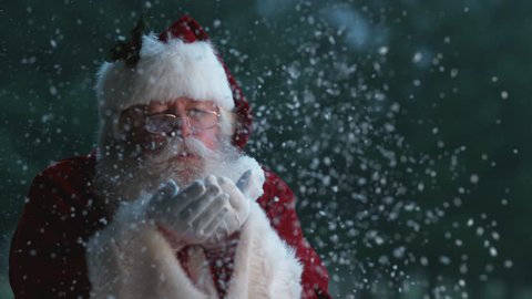 Santa Claus blowing snow from hands in slow motion, Phantom Flex 4K