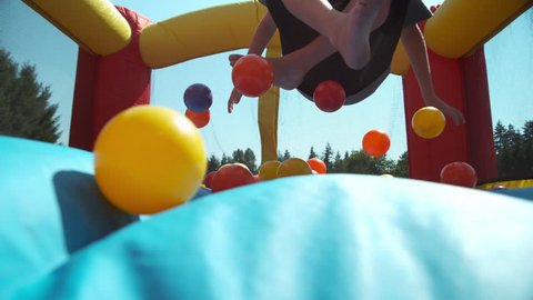 Boy bouncing in inflatable play house, super slow motion
