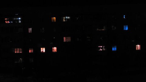 The facade of a residential block of flats in the evening, Timelapse