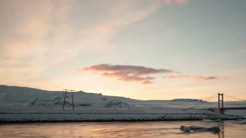 4K Time lapse pan and tilt shot of icebergs moving in the Glacier Lagoon Jokulsarlon in Iceland at sunset