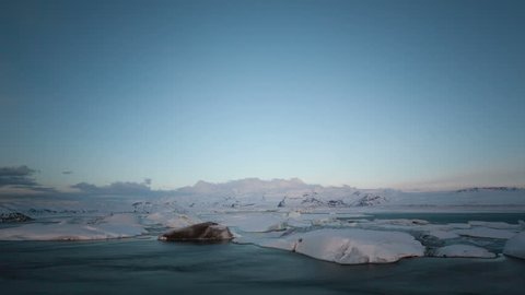 4K Time lapse of icebergs moving in the Glacier Lagoon Jokulsarlon in Iceland at sunrise in the morning