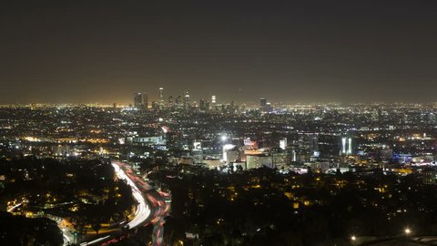 LOS ANGELES, CA, USA - APR 15, 2015: 4K Time lapse of Downtown Los Angeles from Hollywood Hills with Interstate 101 in the foreground during the evening rush hour
