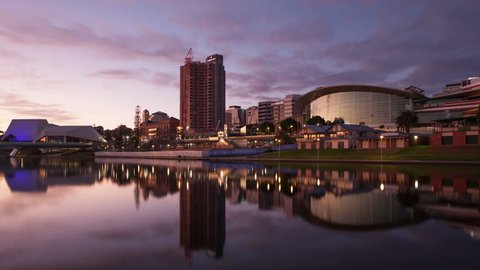 ADELAIDE, SA, AUSTRALIA - JUN 29, 2015: 4K Timelapse zoom in of Adelaide Skyline with Convention Centre and Elder Park Waterfront at sunrise