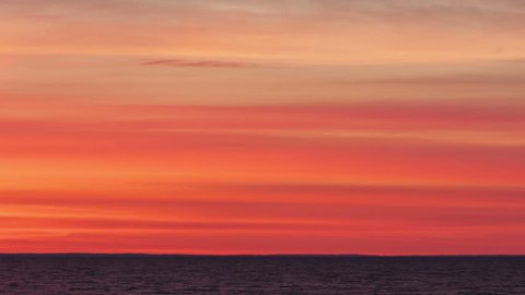 Time lapse close up of a blood red sunrise at lake Huron in Michigan, USA