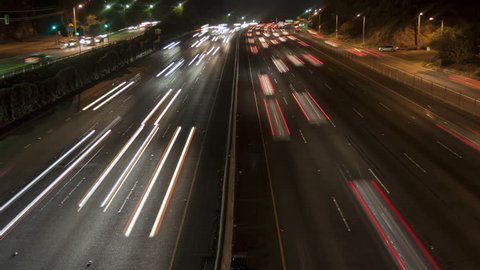 4K Time lapse zoom out night motion light trails on a busy Los Angeles freeway