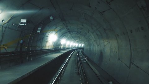 Train riding fast in a dark underground tunnel in the modern city