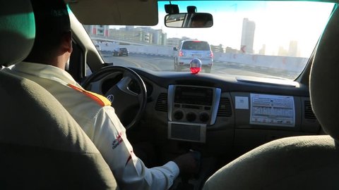 DUBAI, UAE - NOVEMBER 24 : Taxi driver in Dubai in a summer day November 24, 2015, United Arab Emirates