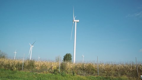 HUNGARY - CIRCA 2016: Motion on fast highway with wind turbines in green fields environmentally friendly electricity production