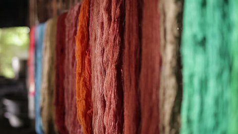 Colorful of raw silk thread on a rail after Dyeing.