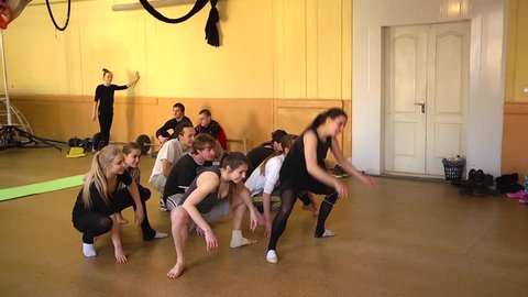 KHERSON, UKRAINE - MAR 11, 2015: Open lesson in circus acrobatics - young people hard train dance movements, endurance and stretching muscles and ligaments