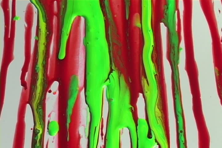 Colorful paints flowing  on a white wall.