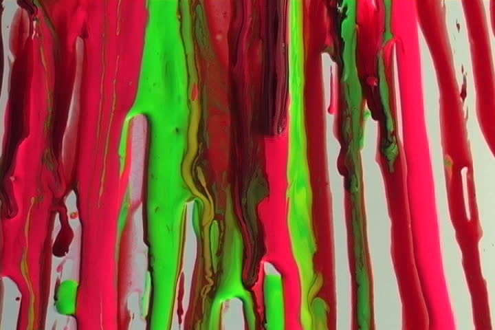 Colorful flowing paint on a white wall.