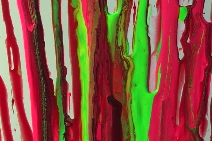 Colorful flowing paint on a white wall.