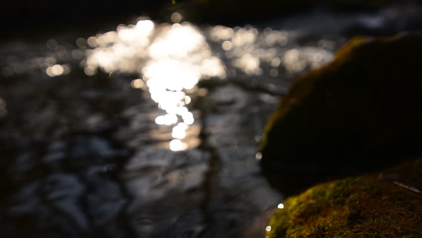 Blur video of the water that flows in the river during sunset in the mountains, background, slow motion