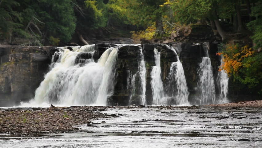 Manabezho Falls, a beautiful waterfall on the Presque Isle River, tumbles over a rocky cliff in the Porcupine Mountains area of Michigan
