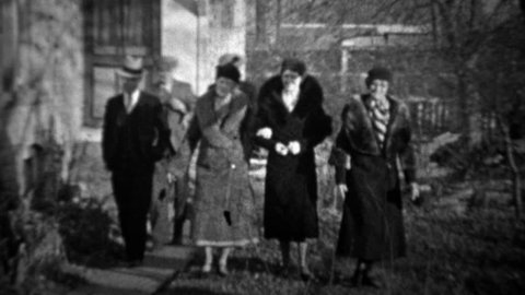 DENVER, COLORADO 1933: Men greeting women tipping cap bowing to pretty wifes.
