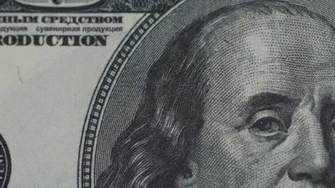 Macro close up slide shot of Ben Franklin's face on the US $100 dollar bill 1