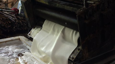 Farmers bring rubber into rubber rolling machines to make rubber sheets