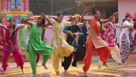Surajkund, India - February 10, 2016:  Teenage girls are dancing with full of energy on the stage in Surajkund public craft fair in Surajkund, Faridabad, India.