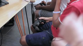 Boys use controllers to play video game