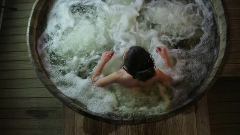 Girl sitting in the jacuzzi.